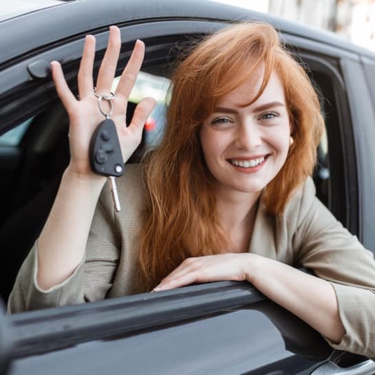 A newly qualified driver holding her car keys after passing